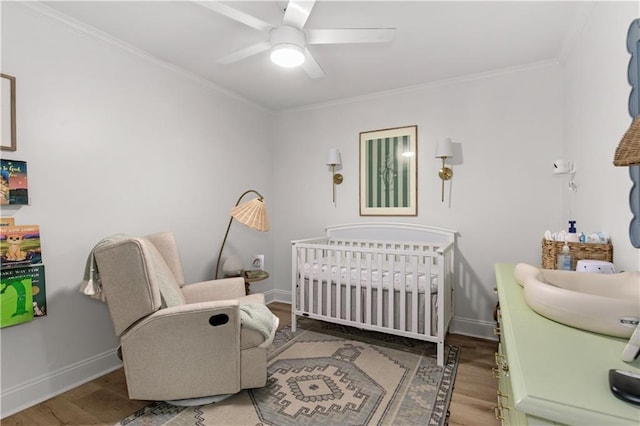4689 Oak Ridge Rd, Mobile, AL 36609 - bedroom featuring wood finished floors, a crib, crown molding, baseboards, and a ceiling fan