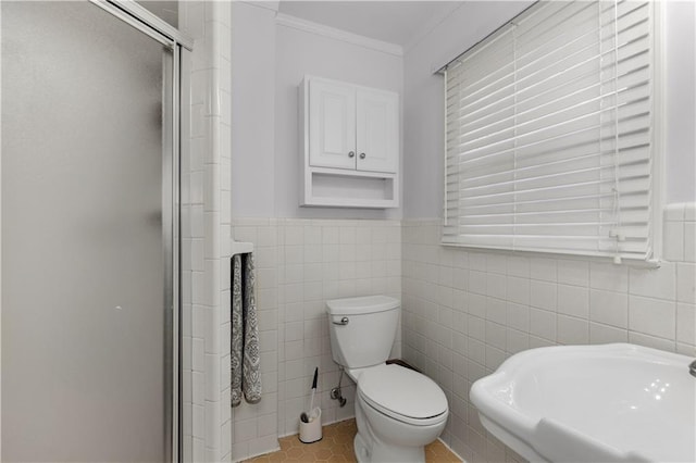 4689 Oak Ridge Rd, Mobile, AL 36609 - bathroom with a stall shower, tile walls, toilet, ornamental molding, and a wainscoted wall