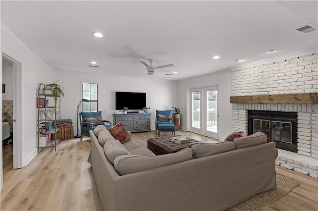 4689 Oak Ridge Rd, Mobile, AL 36609 - living room with crown molding, plenty of natural light, light wood finished floors, ceiling fan, and a fireplace