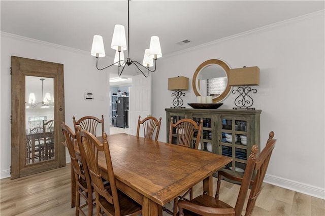 4689 Oak Ridge Rd, Mobile, AL 36609 - dining space featuring a chandelier, light wood finished floors, ornamental molding, and baseboards