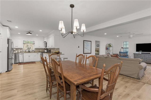 4689 Oak Ridge Rd, Mobile, AL 36609 - dining area with recessed lighting, light wood-style floors, a ceiling fan, a chandelier, and ornamental molding