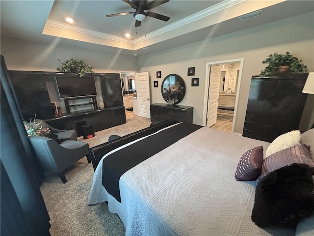 carpeted bedroom with crown molding, ensuite bathroom, a raised ceiling, visible vents, and recessed lighting