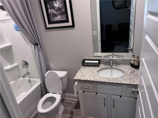 full bath with wood finished floors, shower / bathtub combination, toilet, vanity, and baseboards