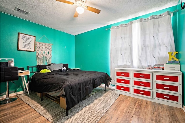 8920A Chunchula-Georgetown Rd, Chunchula, AL 36521 - bedroom with ceiling fan, a textured ceiling, baseboards, wood finished floors, and visible vents