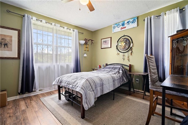 8920A Chunchula-Georgetown Rd, Chunchula, AL 36521 - bedroom featuring baseboards, a ceiling fan, a textured ceiling, and wood finished floors