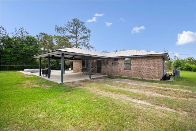 8920A Chunchula-Georgetown Rd, Chunchula, AL 36521 - back of property with ceiling fan, a lawn, a carport, brick siding, and a patio