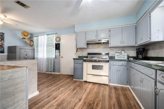 8920A Chunchula-Georgetown Rd, Chunchula, AL 36521 - kitchen featuring a ceiling fan, under cabinet range hood, white range with gas stovetop, and dark countertops
