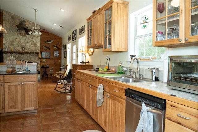 kitchen with hardwood / wood-style floors, vaulted ceiling, dishwasher, tile countertops, and ceiling fan