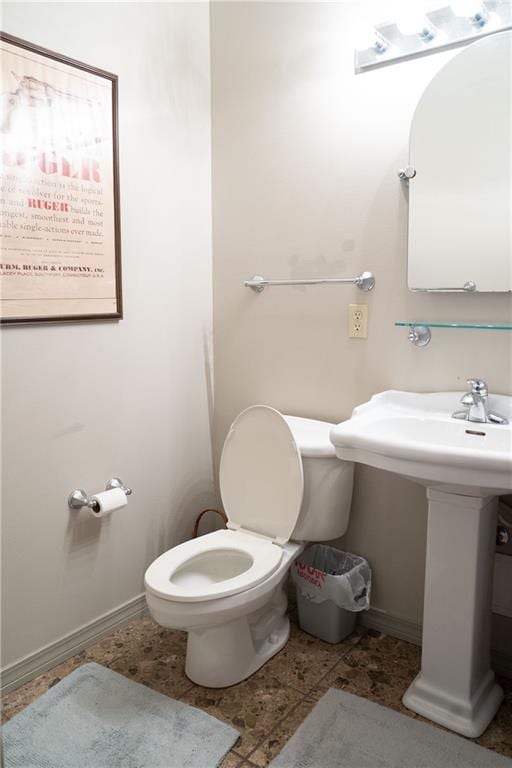 bathroom featuring tile floors and toilet