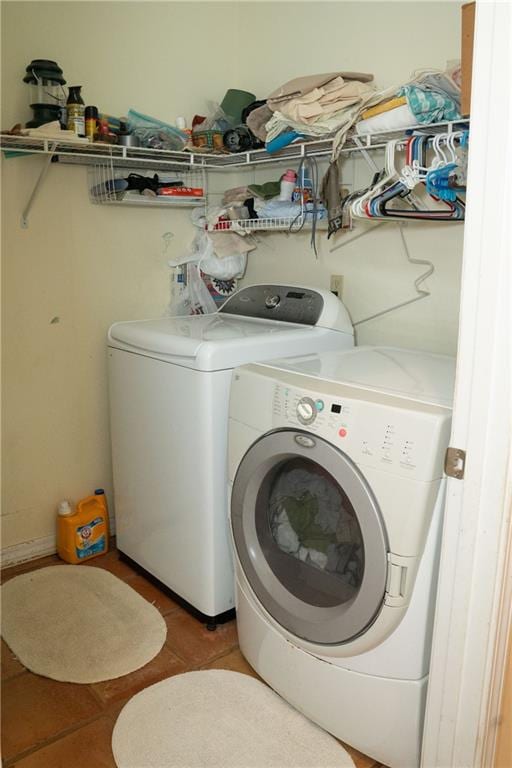 laundry room with tile flooring and washer and clothes dryer