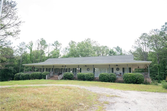 ranch-style home with a porch and a front lawn