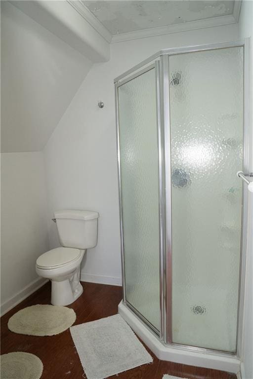 bathroom with hardwood / wood-style floors, an enclosed shower, and toilet