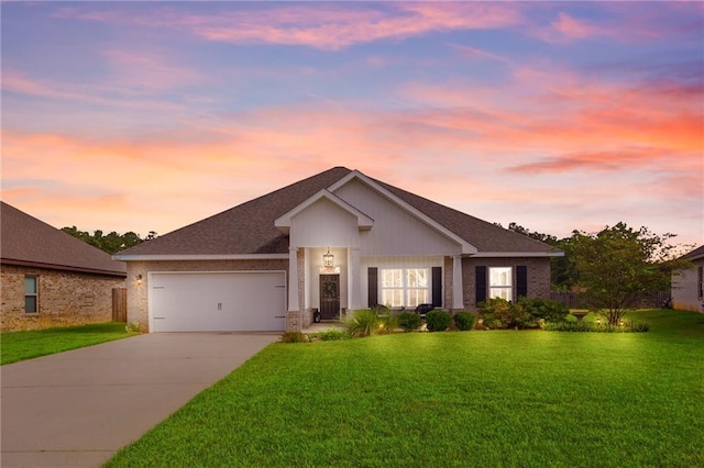 view of front facade featuring a lawn and a garage