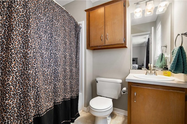 bathroom featuring a shower with shower curtain, vanity, toilet, and baseboards