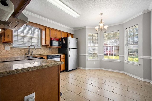 kitchen featuring decorative backsplash, brown cabinetry, appliances with stainless steel finishes, a sink, and exhaust hood