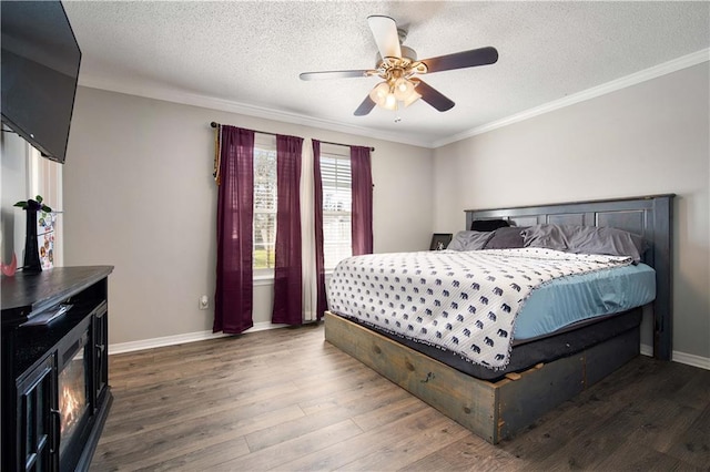 bedroom featuring ornamental molding, baseboards, and wood finished floors