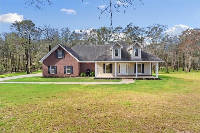 cape cod home featuring a front lawn and a porch