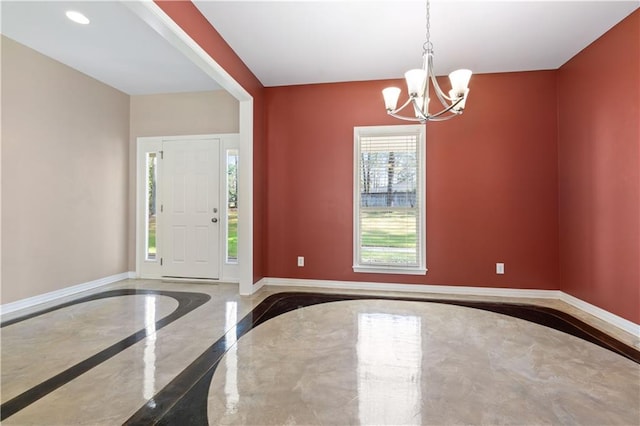 entrance foyer with an inviting chandelier and concrete flooring