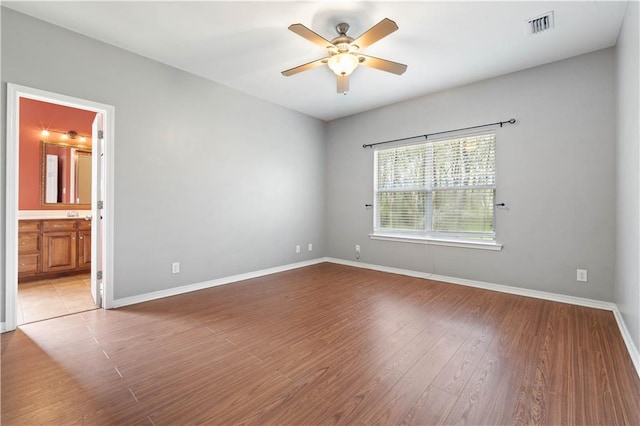 spare room featuring ceiling fan and hardwood / wood-style flooring