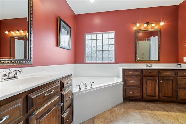 bathroom featuring a washtub, tile patterned flooring, and vanity