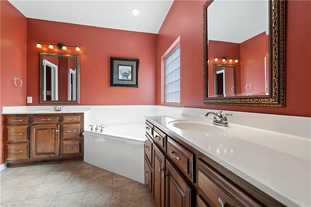 bathroom featuring vanity, tile patterned flooring, and a bath