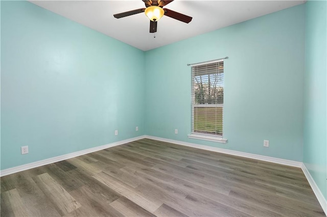 empty room with ceiling fan and light hardwood / wood-style floors