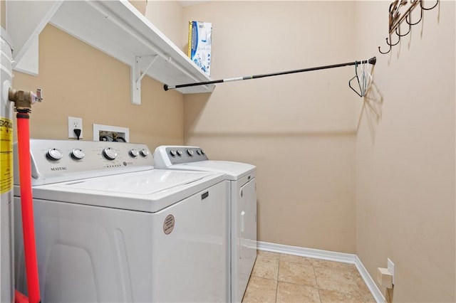 laundry room with light tile patterned floors and independent washer and dryer