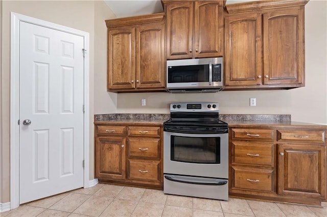 kitchen featuring light tile patterned floors and stainless steel appliances