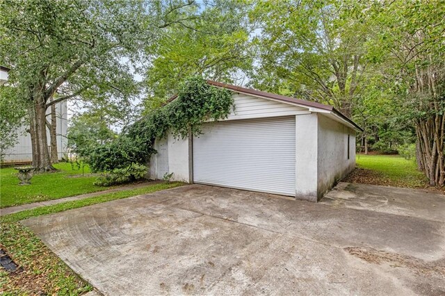 garage featuring a lawn