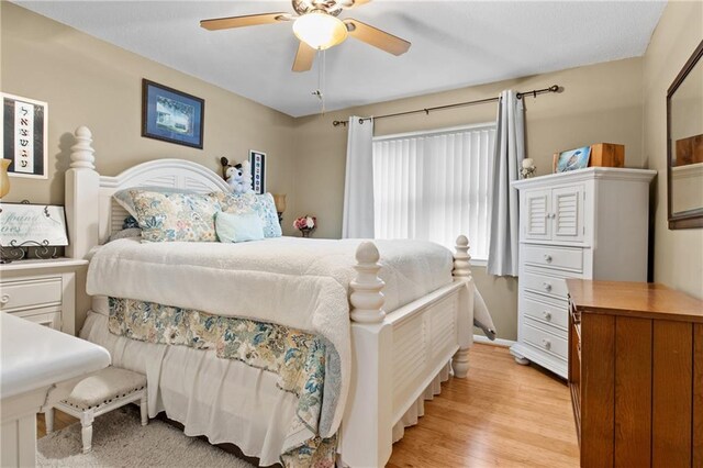 bedroom with ceiling fan and light hardwood / wood-style floors