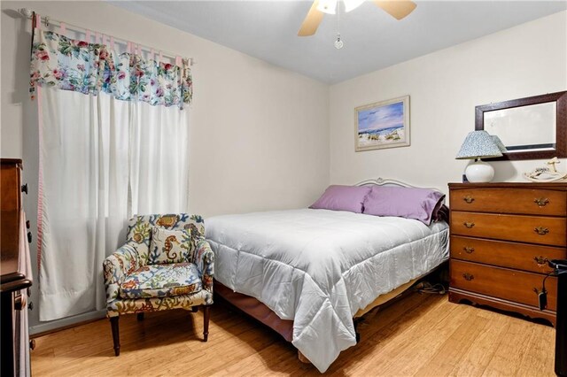 bedroom with ceiling fan and light hardwood / wood-style flooring