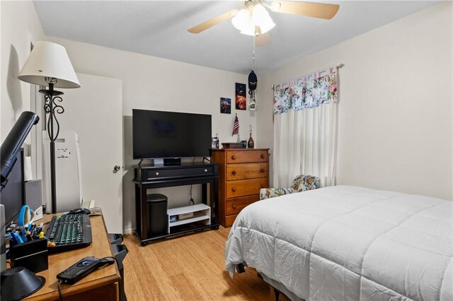 bedroom with hardwood / wood-style flooring and ceiling fan