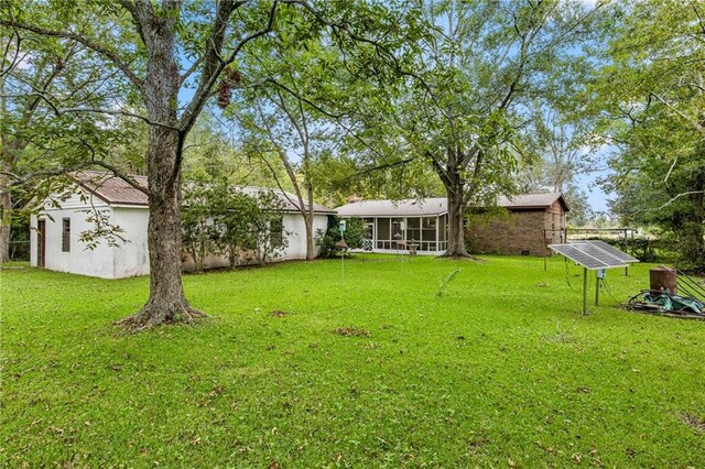 view of yard featuring a sunroom