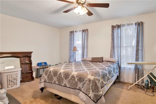 bedroom featuring ceiling fan and light carpet