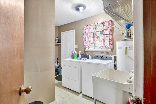 washroom featuring a textured ceiling, sink, washing machine and dryer, and gas water heater