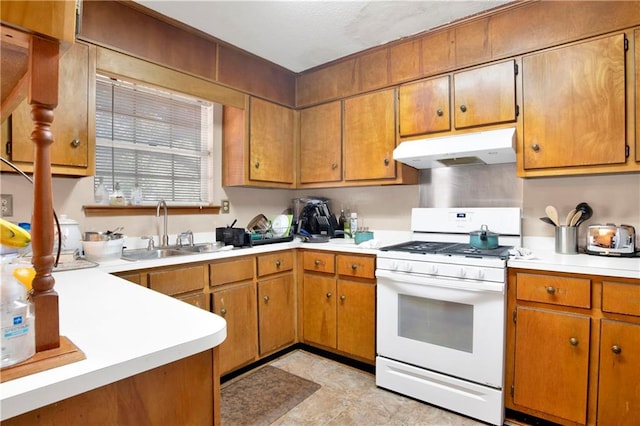 kitchen featuring white gas range and sink