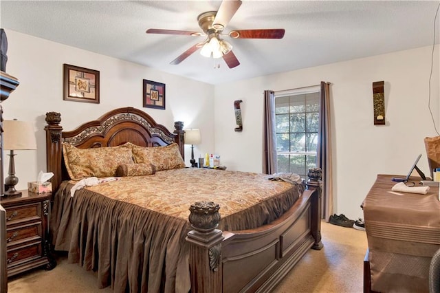 carpeted bedroom featuring ceiling fan and a textured ceiling