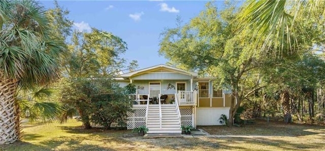 414 Audubon Dr, Dauphin Island, AL 36528 - view of front of house featuring stairway and covered porch