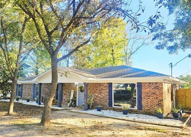 single story home featuring brick siding and fence