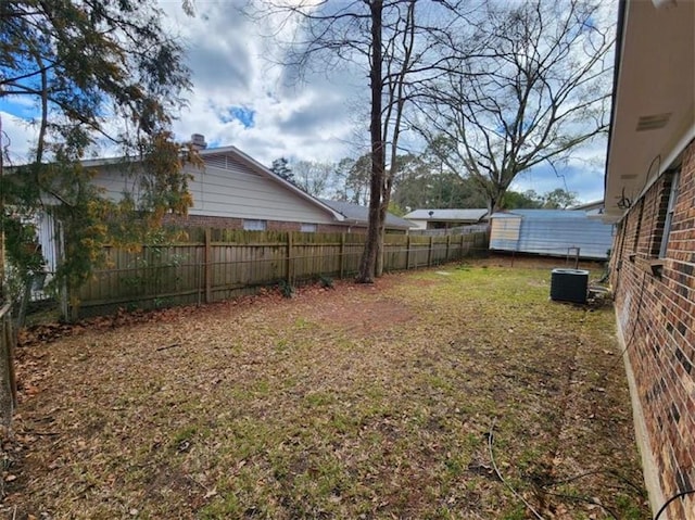 view of yard with cooling unit and fence