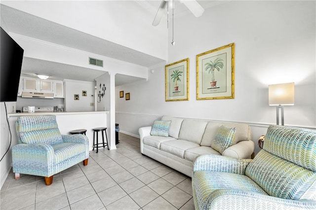 tiled living room featuring ornamental molding and ceiling fan