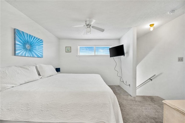 carpeted bedroom with a textured ceiling and ceiling fan