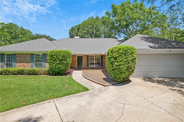 ranch-style house featuring brick siding, a shingled roof, and a front yard