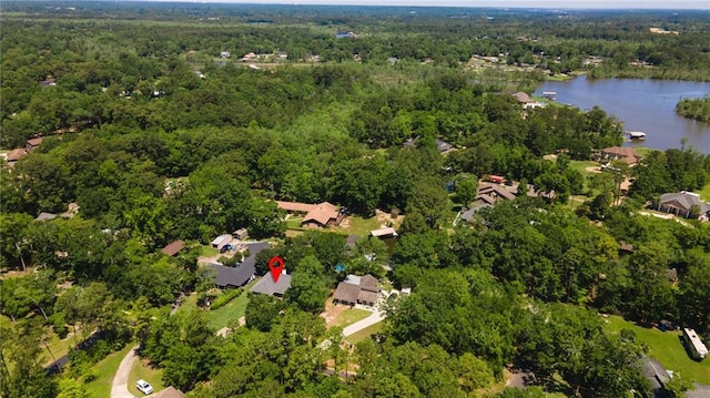 aerial view with a forest view and a water view