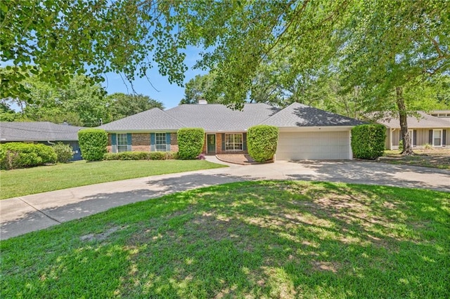 ranch-style home featuring an attached garage, a chimney, concrete driveway, and a front lawn