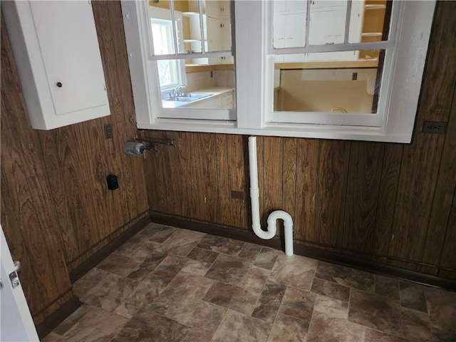 laundry room with wooden walls