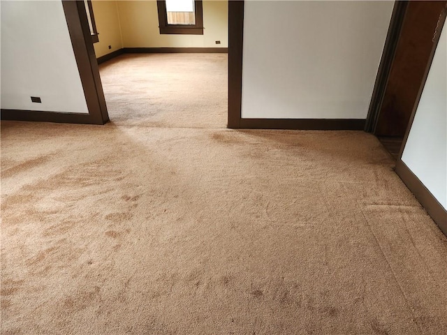 unfurnished room featuring light colored carpet