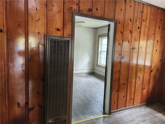 interior space with light hardwood / wood-style flooring and wood walls