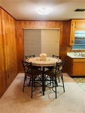 dining space featuring wood walls