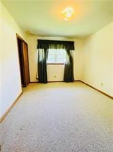 spare room featuring light colored carpet